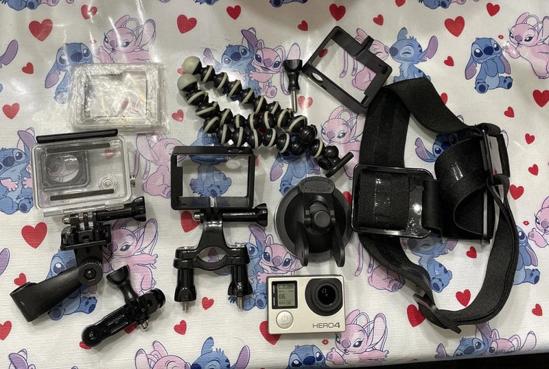 Black action camera with mounts, protective housing, strap, and accessory case