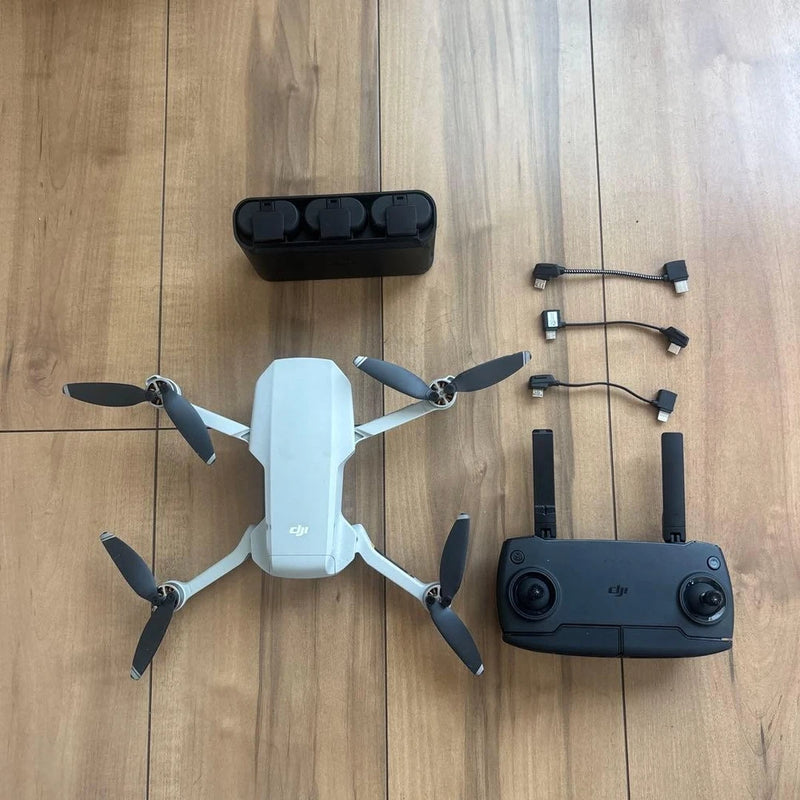 Dji quadcopter drone with camera and four propellers, plus remote controller