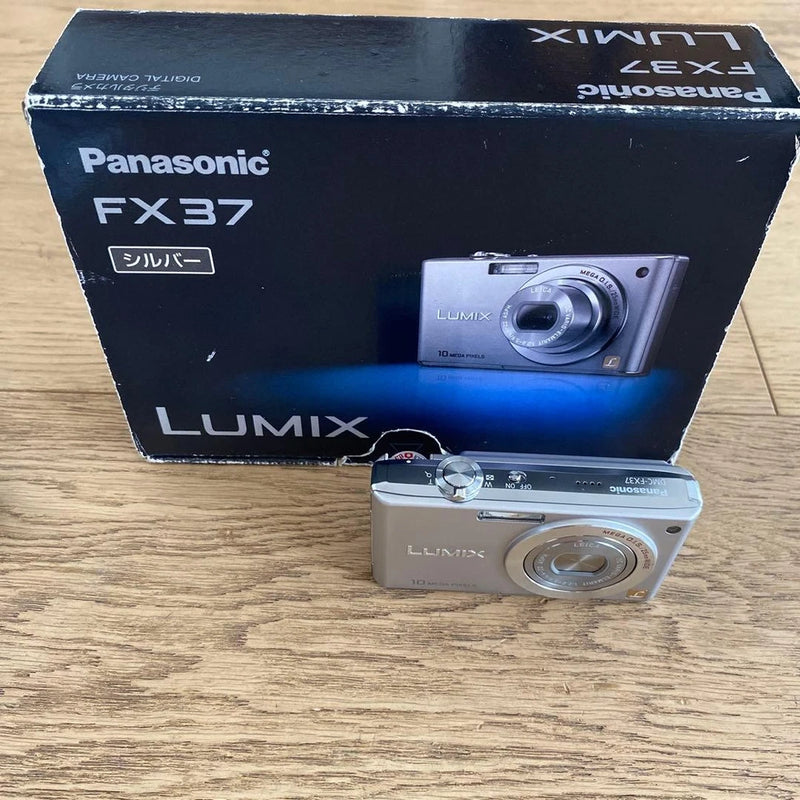Panasonic LUMIX FX37 compact camera with silver body and retail box