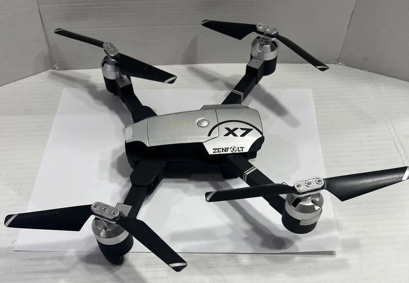 Foldable quadcopter drone with four propellers, gray body, X7 label