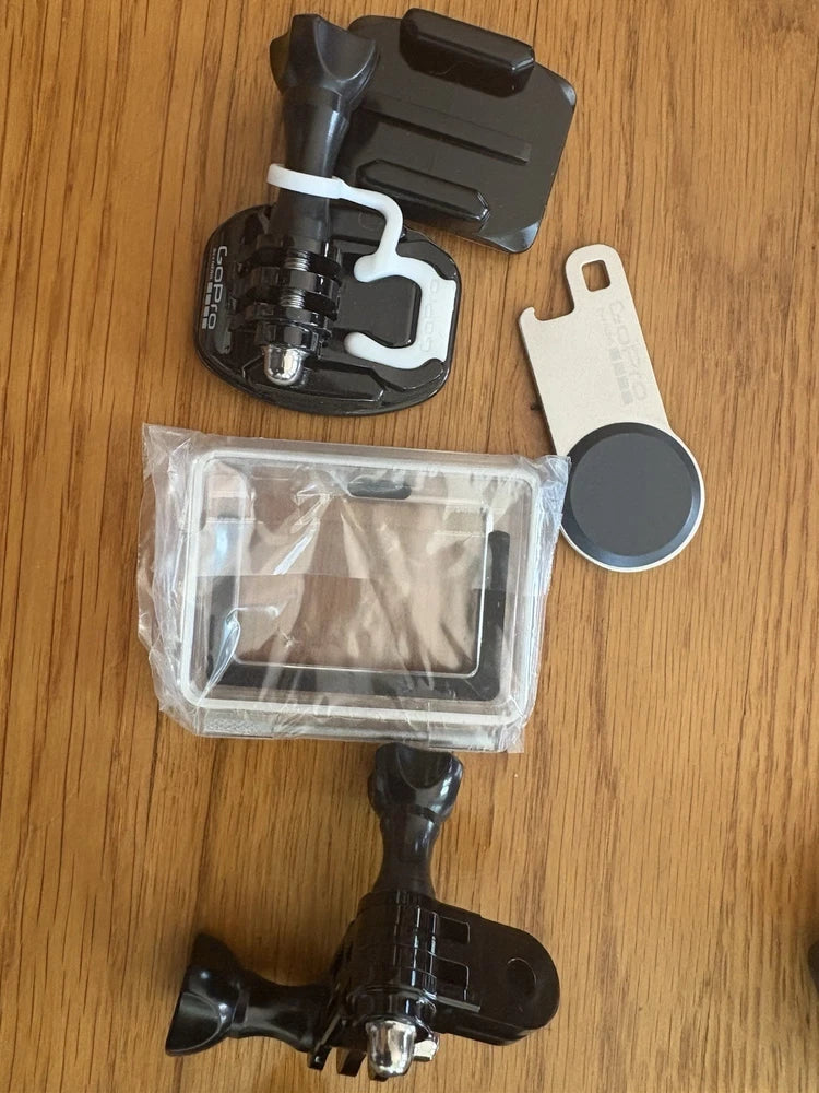 GoPro HERO3 action camera in clear waterproof case with mount, strap, lens cover