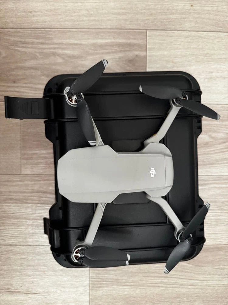 Dji Mavic Mini drone with folded propellers, black and light gray body