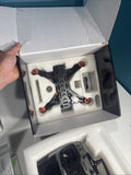 Black quadcopter mini drone with red arms in open molded foam box