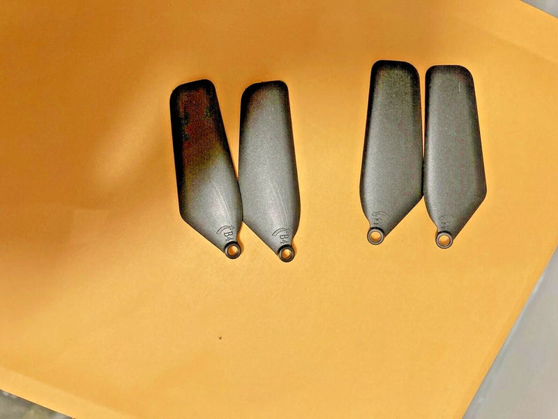 Drone propeller blade set with four dark gray curved blades