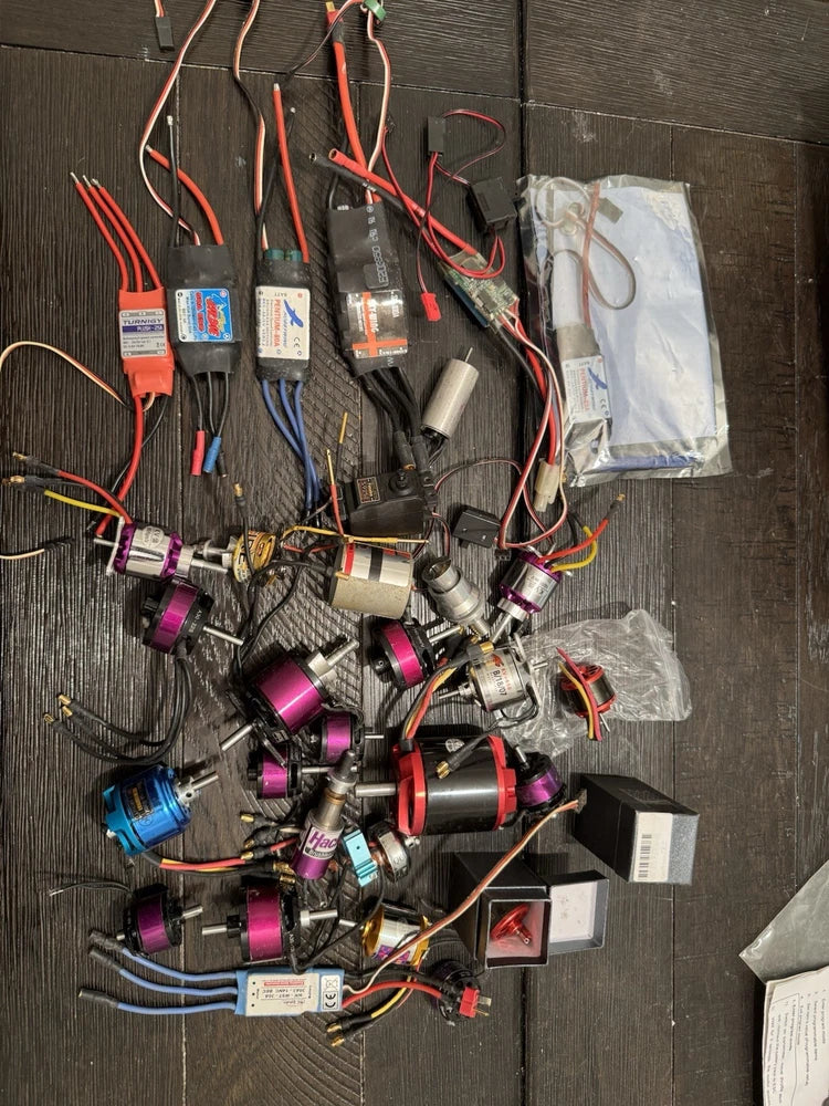 RC drone motor lot with multiple wired motors and connectors, various colors