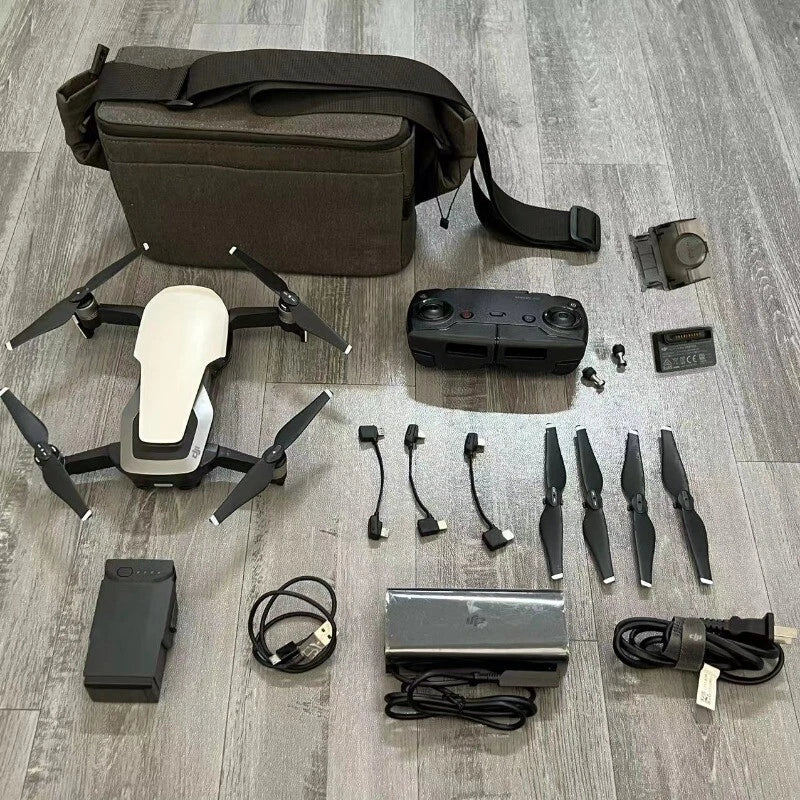 Drone kit with controller, batteries, propellers, and carrying bag