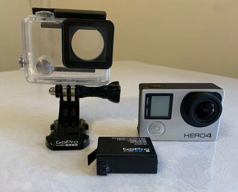 Silver GoPro HERO4 action camera with waterproof housing, camera mount and accessories