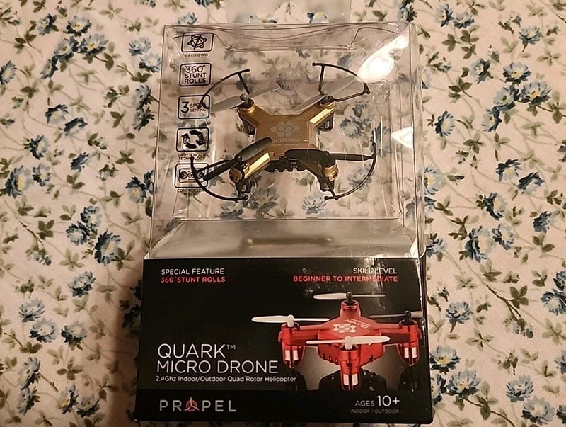 Quark micro drone quadcopter in box, red body with four black rotors