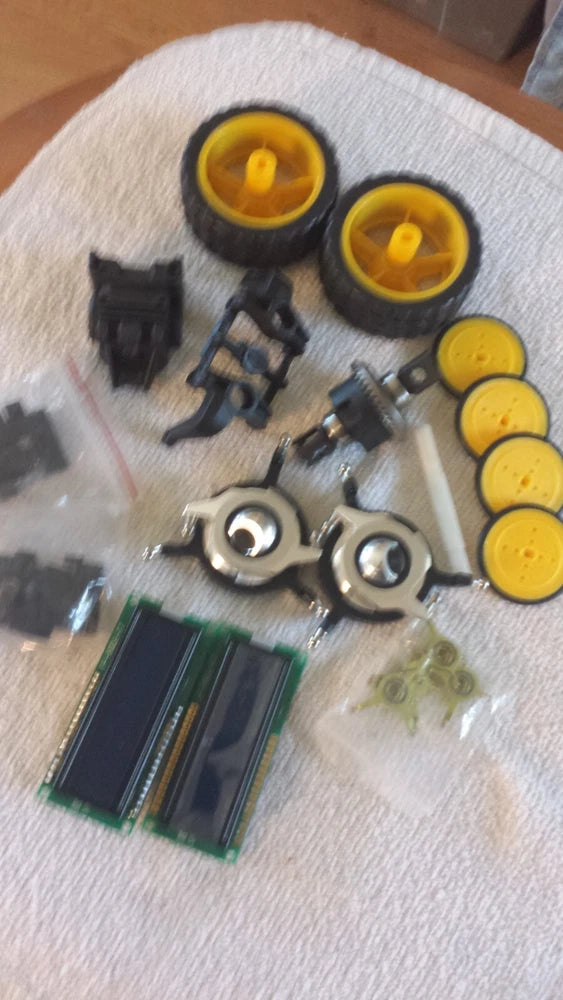 Steampunk robotic drone parts kit with yellow wheel-like discs and metal gears