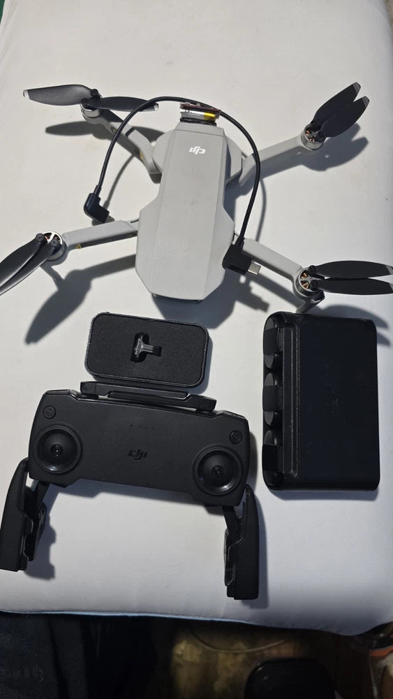 DJI Mavic Mini camera drone with controller and phone mount, front view