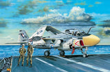 Gray jet aircraft with cockpit open and colorful nose markings, on carrier deck