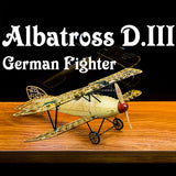 Wooden static airplane model with biplane wings, red nose, and yellow framework