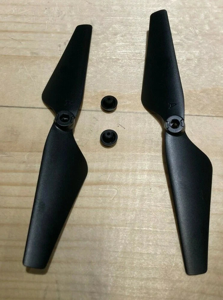 Pair of black FPV drone propeller blades with mounting screws