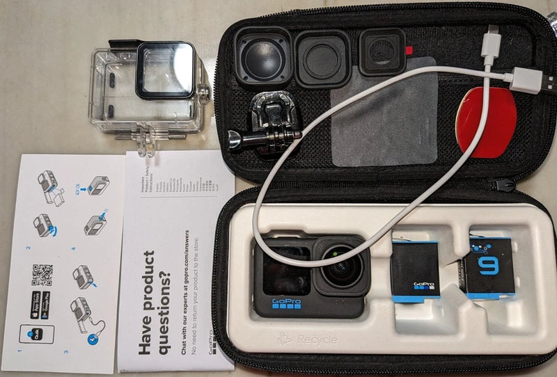 GoPro action camera kit in zip case with camera modules, mounts, and accessories