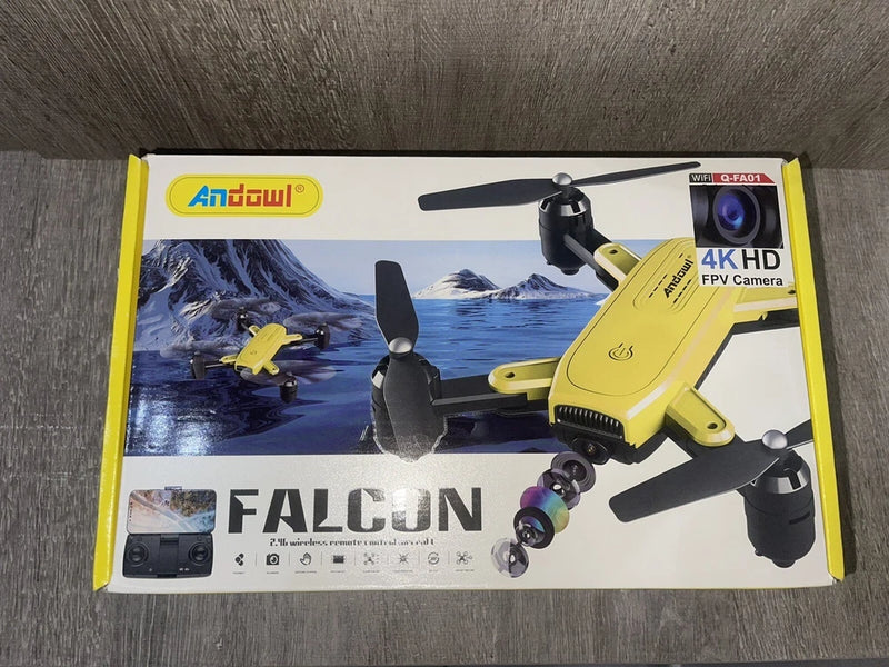 Yellow Falcon drone with 4K HD camera, four propellers, shown on retail box