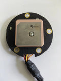 Round GPS module PCB with button label and wire harness connection