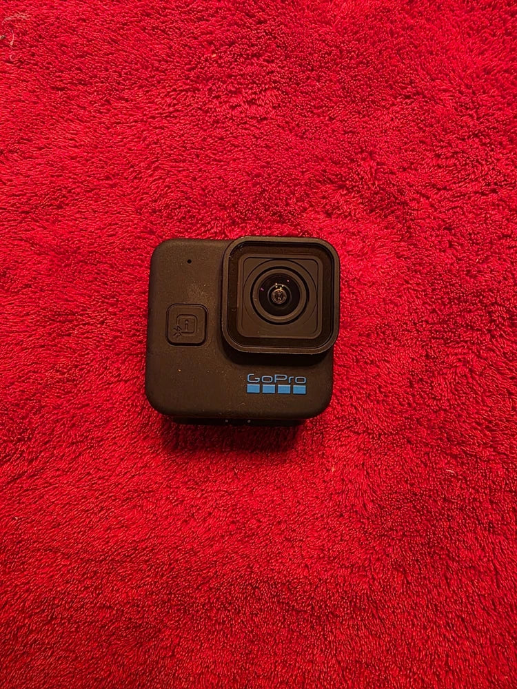 GoPro HERO11 Black action camera, front view with lens and small side buttons