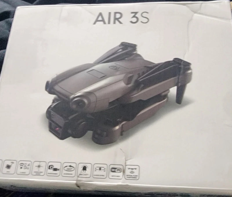Foldable gray-and-black quadcopter drone with built-in camera module