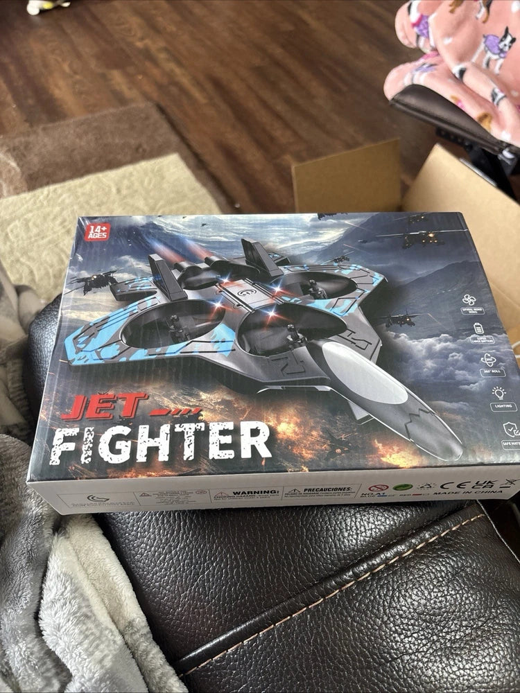 Blue RC jet fighter drone quadcopter toy in sealed retail box with lights