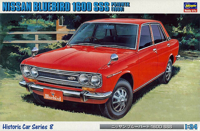 Red classic sedan model car with chrome grille and front three-quarter view