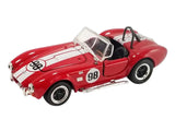Red/white 1965 Shelby Cobra model car with #98, open cockpit, front three-quarter view