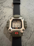 Casio G-Shock DW-6400 digital watch with black strap, dark bezel, red G logo