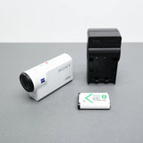 Sony 4K action cam with white body, charging dock, and NP-BX1 battery