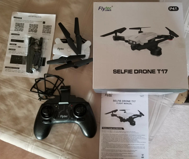 FLYTEC T-17 selfie drone with controller and manuals, shown with accessories and box