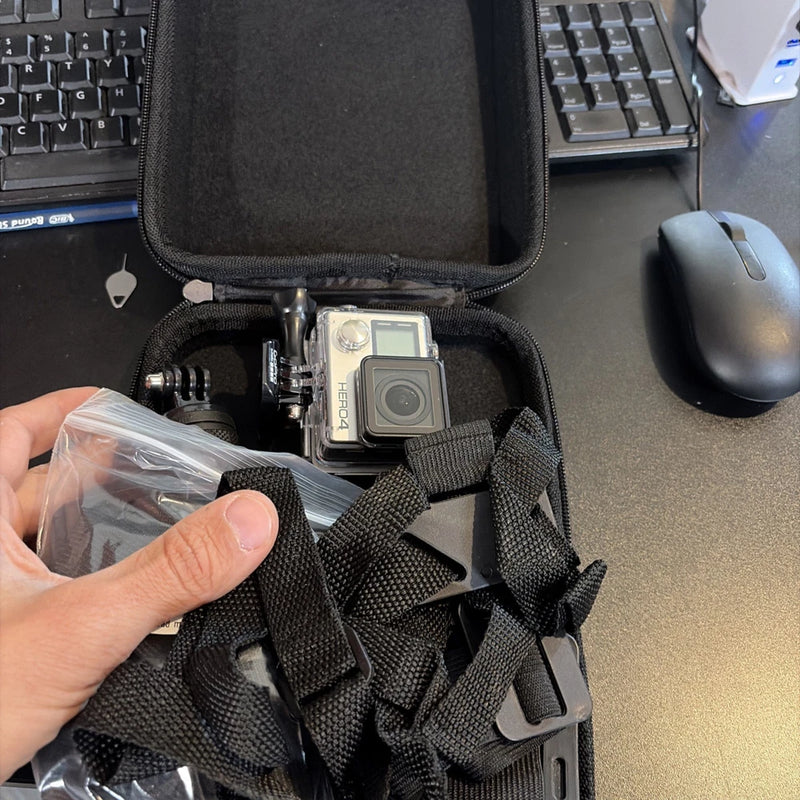 GoPro action camera in black zip case with mounting straps and plastic accessory bag