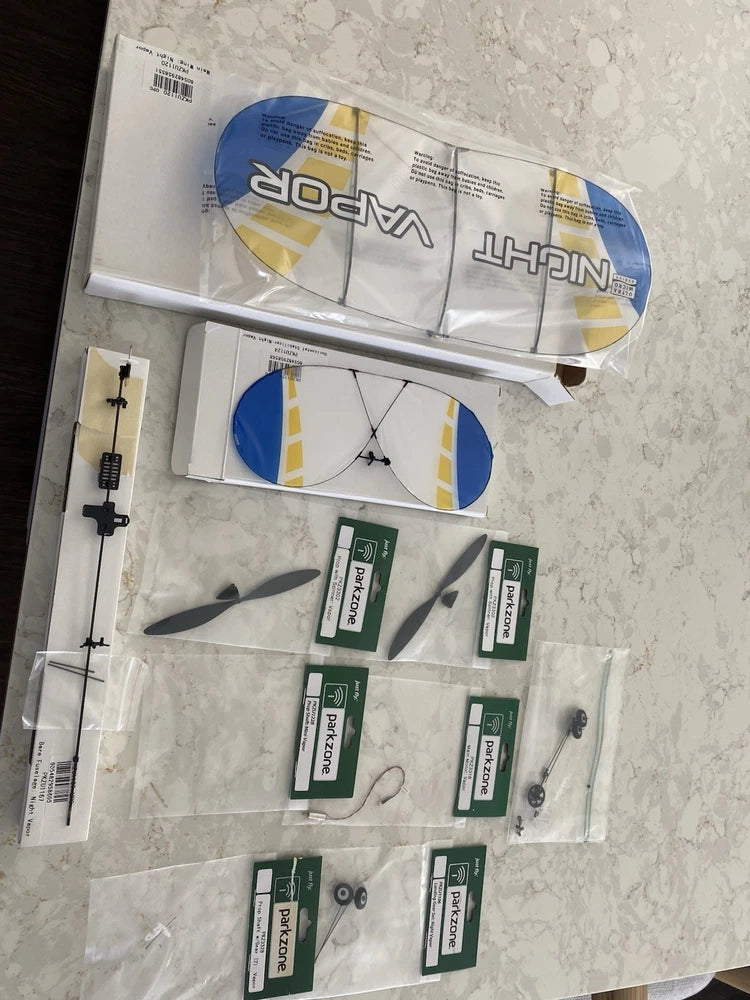 RC model airplane replacement parts kit in plastic bag with blue-and-yellow pieces