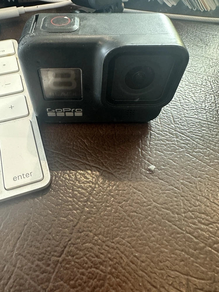 GoPro HERO8 Black action camera front and lens, rugged black housing with status screen
