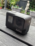 GoPro HERO7 Black action camera with front lens and small LCD screen