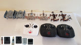 Drone parts set with two black controllers, one white remote, and assorted components