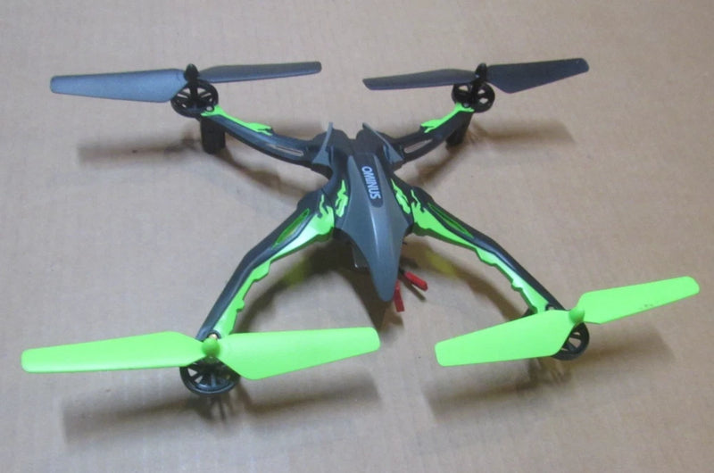 Green and gray quadcopter drone with four propellers and glowing LEDs