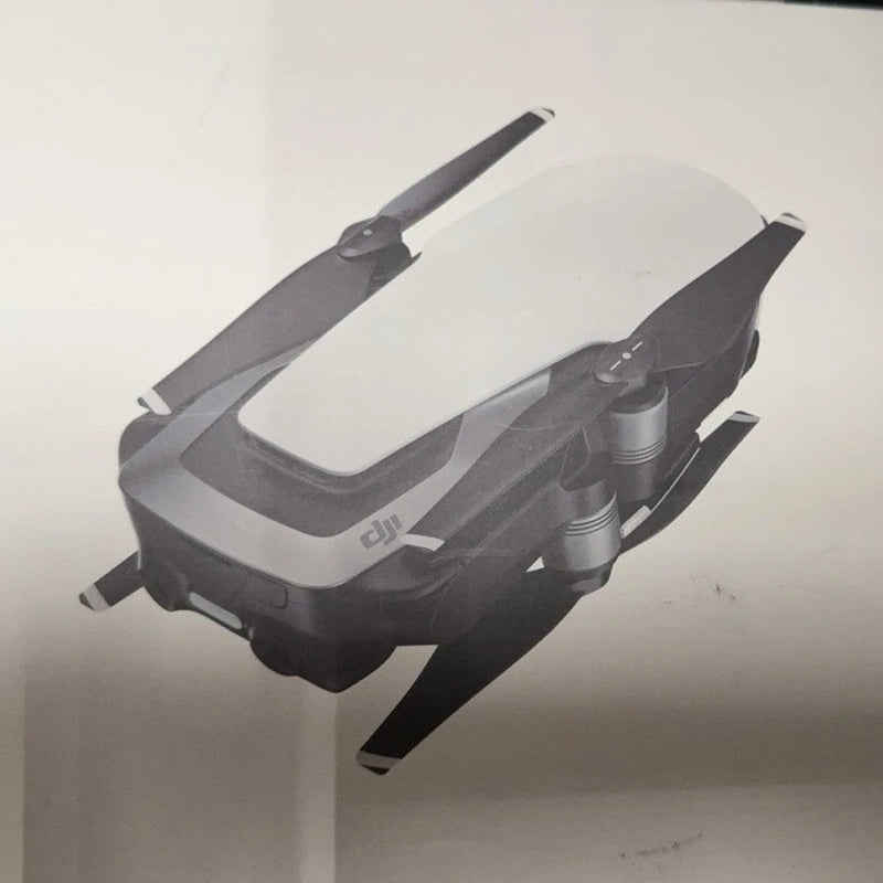 Folded quadcopter drone in gray and black with visible propellers