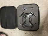 Drone with camera in black hard case, foldable quadcopter with four propellers