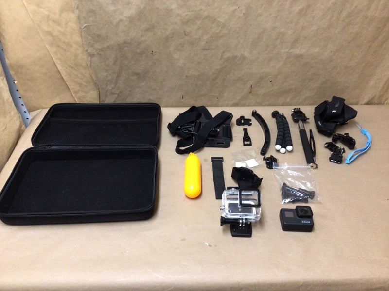Black GoPro action camera bundle with waterproof housing, mounts, cables, and carrying case