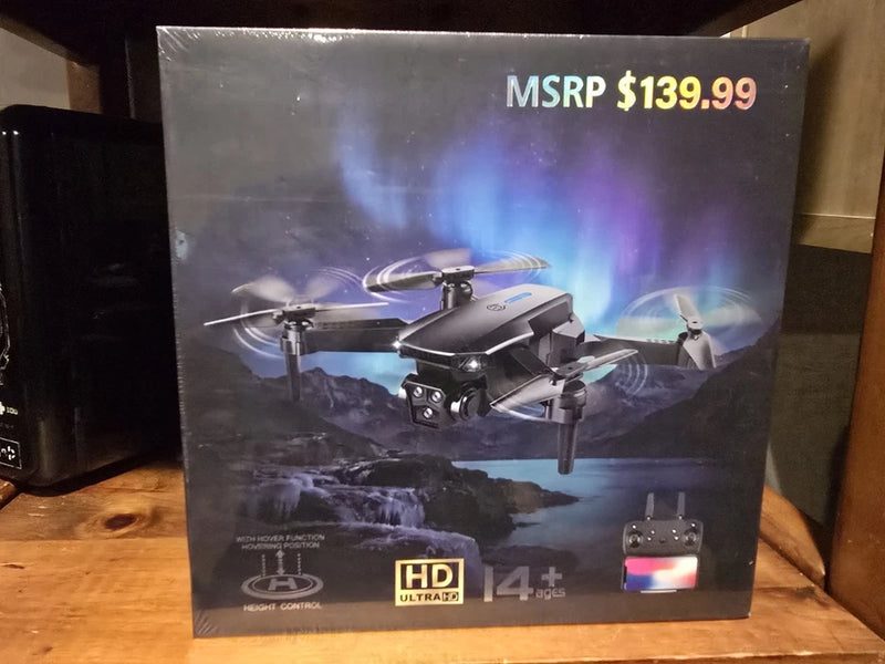 Folding dual-lens HD camera drone with remote controller, shown in retail box
