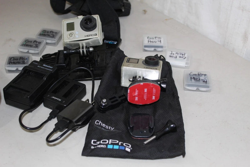 GoPro HERO action camera with chest mount and battery/charger accessories, lot set