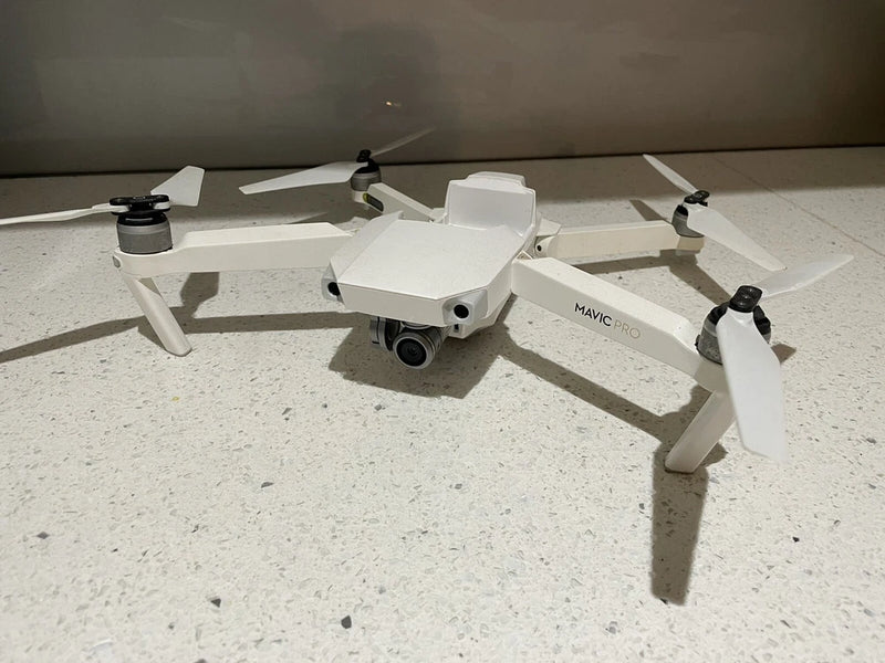 White DJI Mavic Pro 4K quadcopter drone with front camera and four rotors