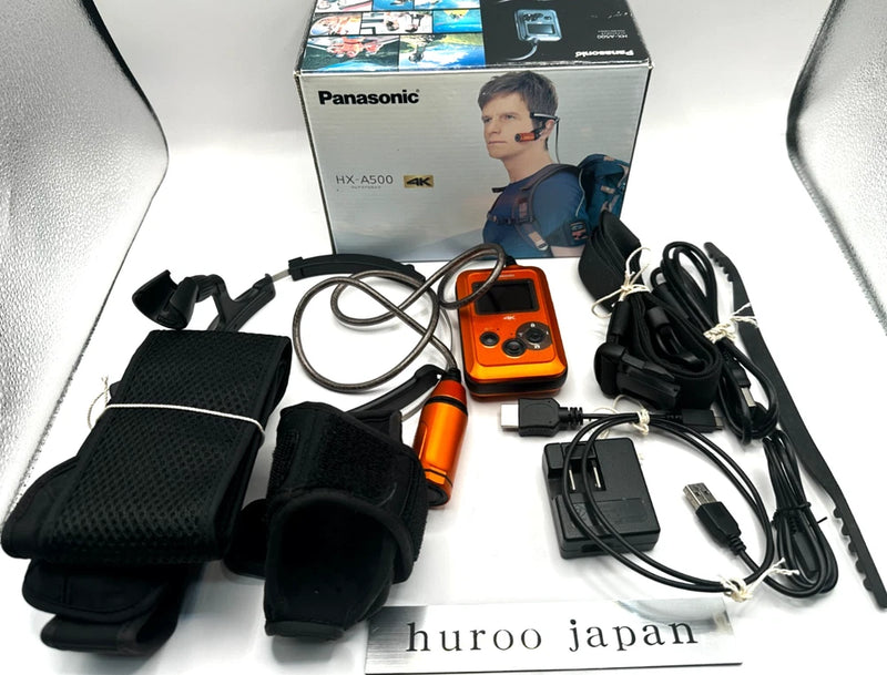 Orange Panasonic HX-A500 wearable 4K POV camcorder with chest mount and cables, tested.