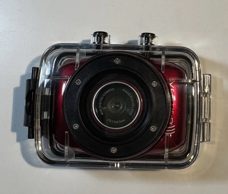 Waterproof digital action camera in clear case with black front lens and metal side latches