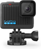GoPro action camera with front lens and black mount base, side view
