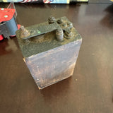 Antique battery box with metal terminals and weathered cover