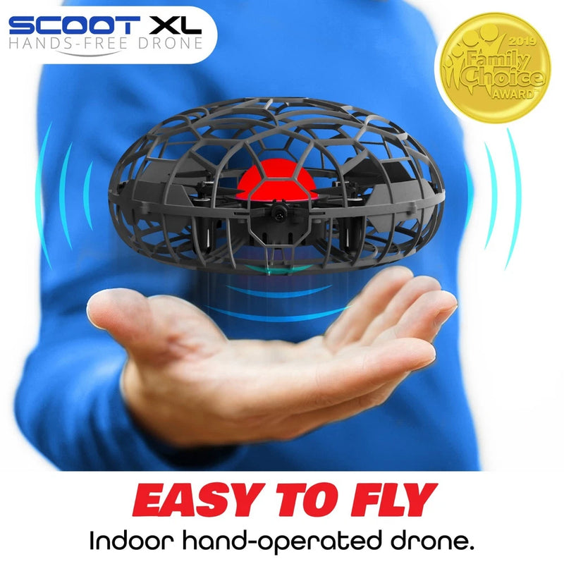 Hand-operated drone with black cage body and red center, held in hands