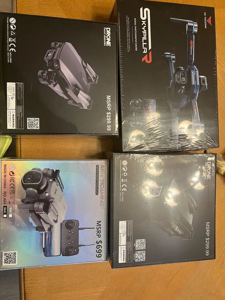 Four drones in unopened retail boxes, shown side by side