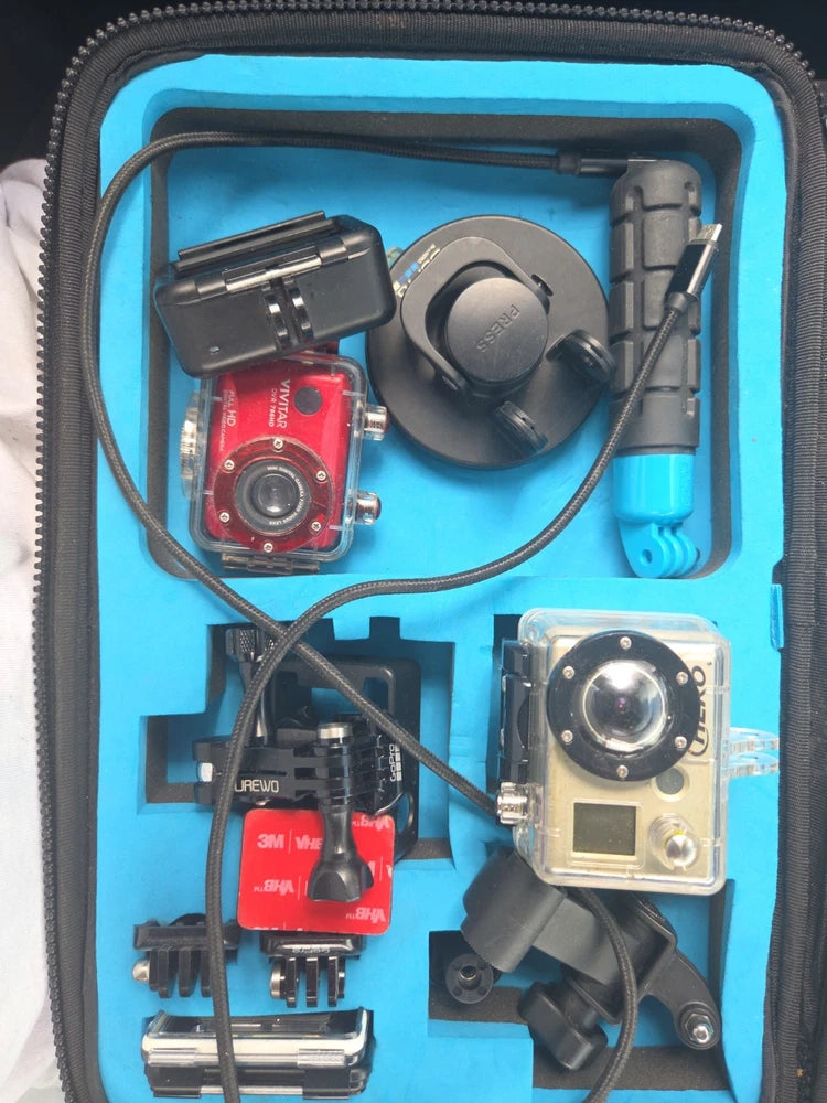 Action camera waterproof case with HERO4-style camera and mounts, cables, and battery