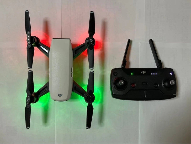 DJI Spark drone body with four propellers and black remote controller