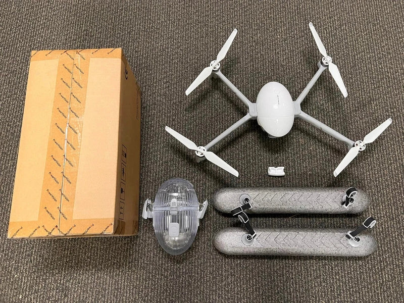 PowerVision drone dummy unit with white body, four propellers, and spare parts