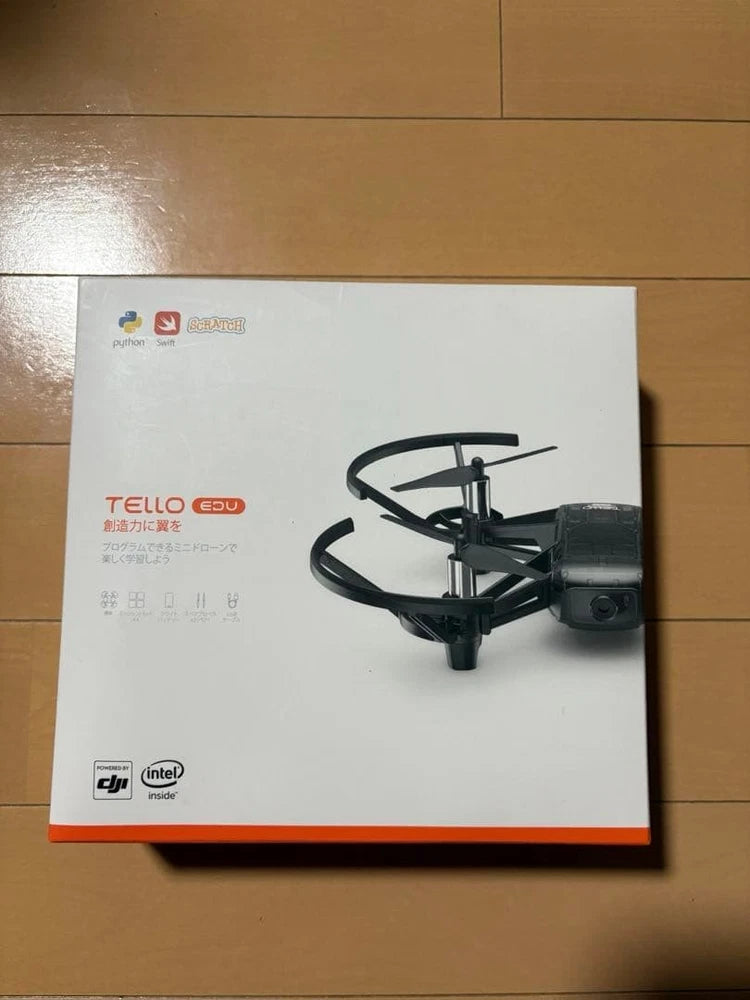 Dji Tello EDU drone toy in retail box, shown with four propellers